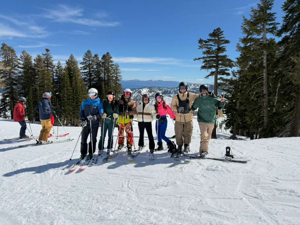SnowEO group on skis and snowboard above Lake Tahoe